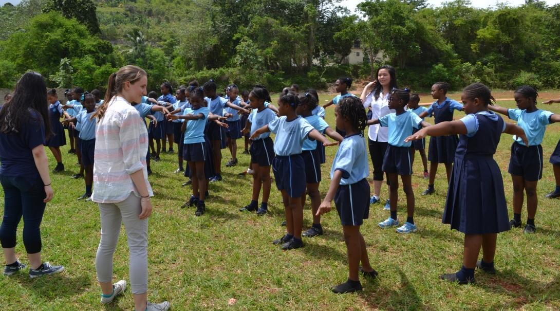 On the Projects Abroad Public Health Internship for teenagers in Jamaica, students lead an exercise activity at a local school. As part of the Public Health placement for teenagers in Jamaica, students have fun with school children during an exercise activity.
